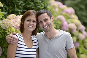 happy younger couple in a garden