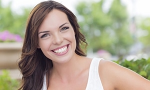 Woman who received porcelain veneers for tmj treatment.