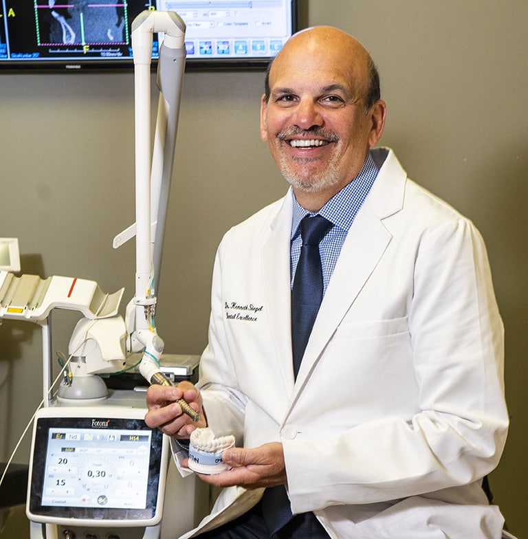 Dr. Ken Siegel with a hard tissue laser machine
